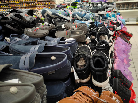 KUALA LUMPUR, MALAYSIA -AUGUST 18, 2020: Colorful pair of slippers and shoes displayed for sale. Each pair has a price tag for the convenience of customers.のeditorial素材