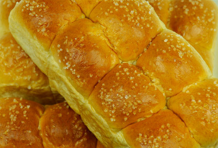 Isolated small sweet bun bread with topping against the white background.