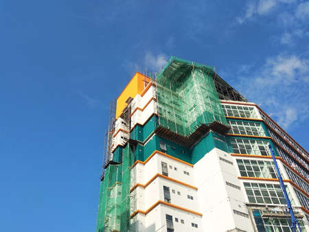 KUALA LUMPUR, MALAYSIA -JULY 16 2019: Catch platform and safety netting at the exterior of the building during high-rise building construction. It protects individuals and property from falling debrisのeditorial素材