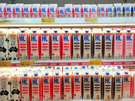PENANG, MALAYSIA -JULY 9, 2020: Selected focused on milk drinks in boxes that come with various flavors and brands. Displayed on cold shelves. Placed price tag.のeditorial素材