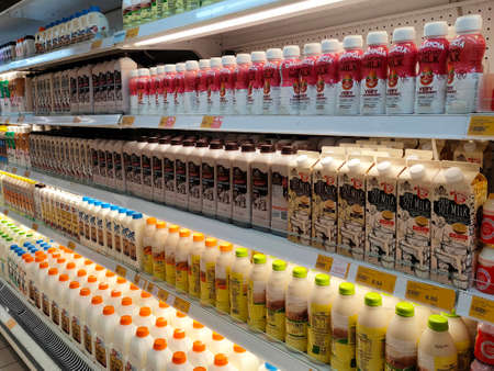 PENANG, MALAYSIA -JULY 9, 2020: Selected focused on milk drinks in boxes that come with various flavors and brands. Displayed on cold shelves. Placed price tag.のeditorial素材