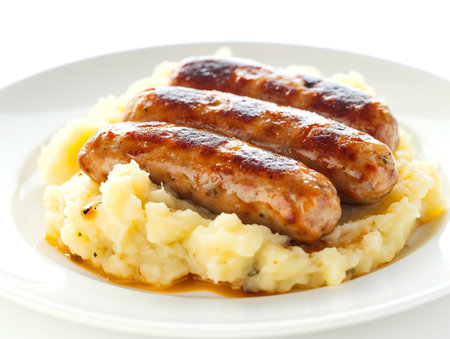 Grilled Sausages with Mashed Potatoes on White Plateの素材