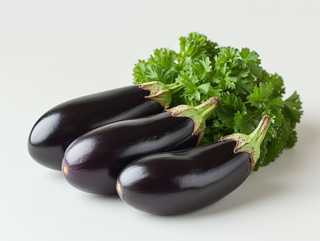 Fresh eggplants and parsley on white background, closeupの素材