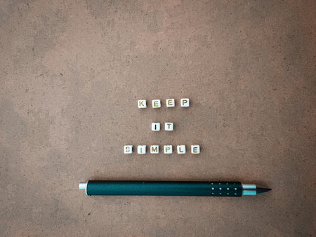 'Keep It Simple' phrase with pen on  the cardboard.