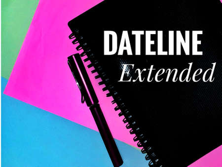 Dateline Extended. Written on a note book with a pen on colorful paper background.の写真素材