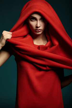 Beautiful woman with red hood  Fashion  Portrait  Close up の写真素材