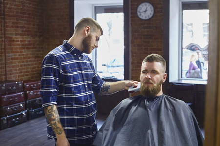 Trimming beard in the Barber shop. Closeup.の写真素材