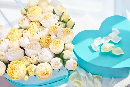 Bouquets of paper flowers in cardboard boxes in the shape of a heart.の写真素材