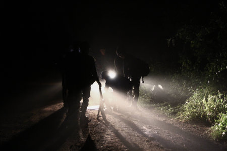 Silhouette Soldiers in the fog on the road in the dark night by lighting.の写真素材