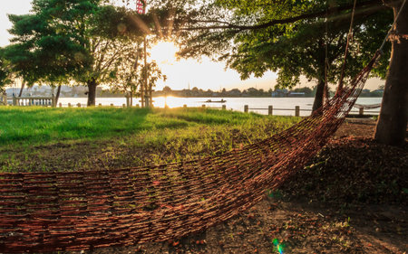 sun shining with hammock  In Thailand  at riverside view.