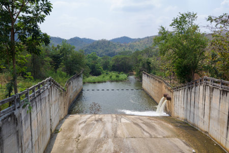 spillway and the reservoir with forest and water conservation in Thailand.の写真素材