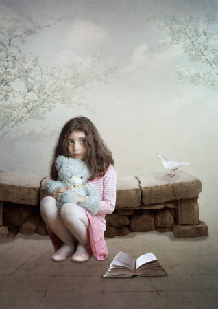  Little girl with teddy bear sitting on his haunches and dreamsの写真素材