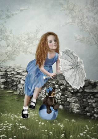 The little girl on nature with an umbrellaの写真素材