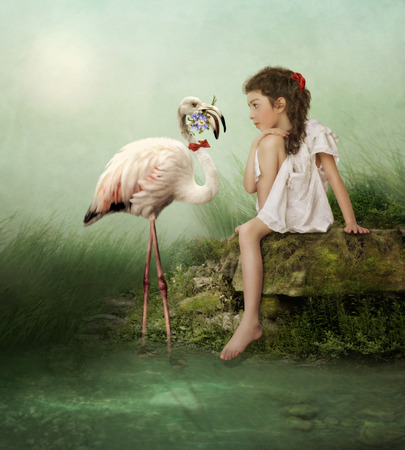 White flamingo with flowers and the little girlの写真素材
