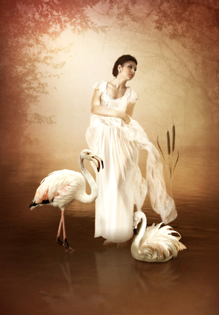 The girl and pink flamingosの写真素材