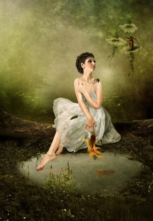 The girl in the woods listens a serenade grasshopperの写真素材