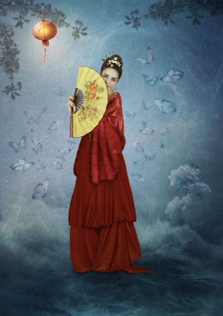 Girl with fan, surrounded by butterflies and flashlightの写真素材