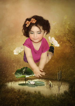Little girl with a smile, frog and fishの写真素材