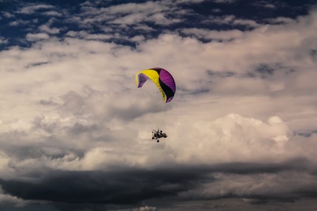 Flying over the Indian ocean on the powered parachute next to the cloud.の写真素材