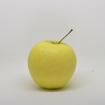 Red yellow apple with green leaf and slice isolated on white backgroundの写真素材