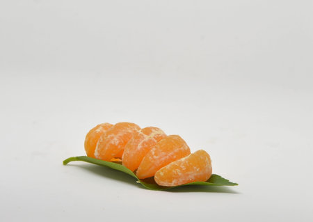 Ripe mandarin with leaves close-up on a white background. Tangerine orange with leaves on a white background.の写真素材