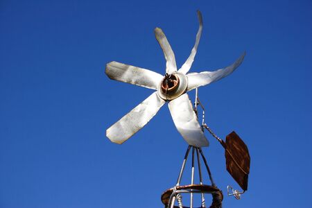 A small and rusted old tin windmillの写真素材