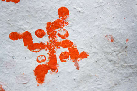 The symbol  on a white wall. is a geometrical figure and an ancient religious icon in the cultures of Eurasia. It is used as a symbol of divinity and spirituality in Indian religions.の写真素材