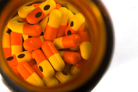 A image showing capsules in a bottle on isolated background with clipping path. These are made for the patient having dieseage of Eplipsey.の写真素材