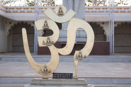 Om metal sign displayed in a hindu temple at Indiaのeditorial素材