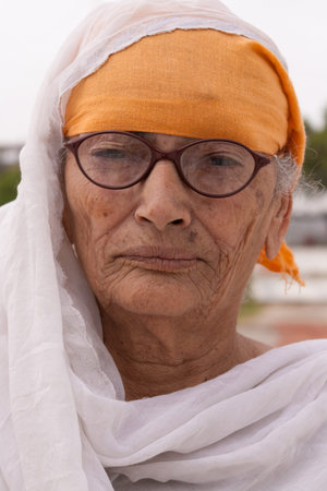 A portrait of an happy Indian religious Sikh woman near Gurdwara (Temple of Sikh community).