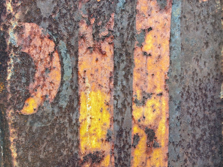 Closeup rusted grunge metal surface with white yellow paint