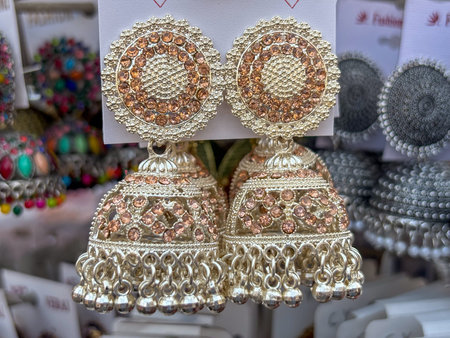 Indian woman ear ring jewellery displayed in street shop closeup