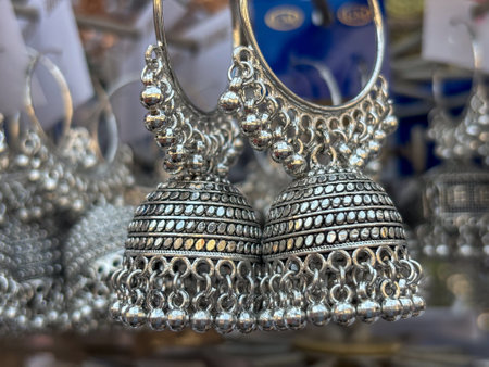 Indian woman ear ring jewellery displayed in street shop closeupの写真素材