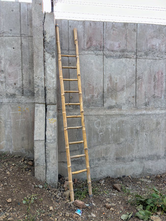 Wooden ladder against concrete wall closeupの写真素材