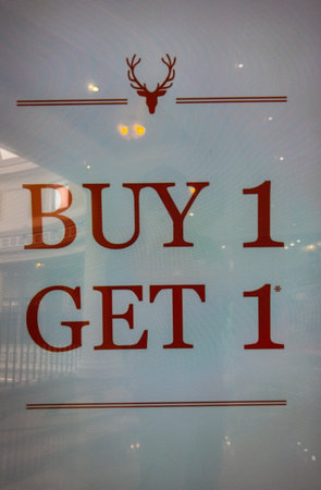 Buy 1 Get 1 Free text message displayed in front of a shopの写真素材
