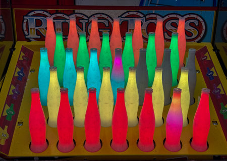 Colorful illuminated bowling pins in an arcade game setup.の写真素材