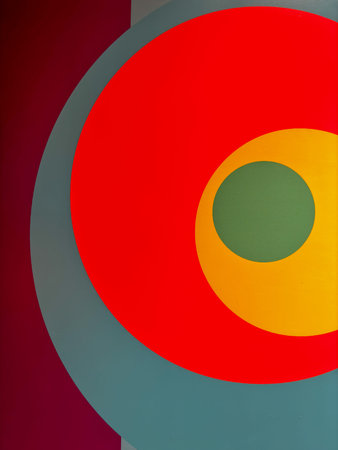 The image is a colorful abstract painting with four different colored circles. The circles are...