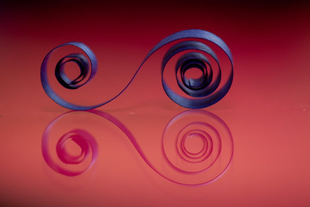 A piece of paper is curled into a spiral shape. The image has a warm, inviting mood, and the color...