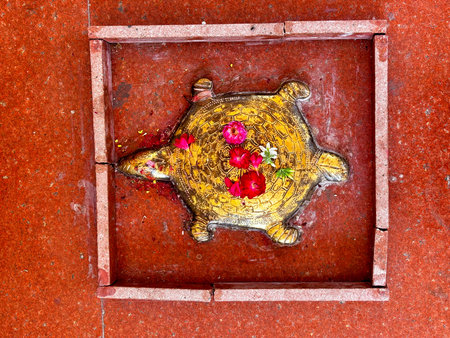 Metal turtle on a brown tiles in a Mahadev temple near Nashik, India.の写真素材