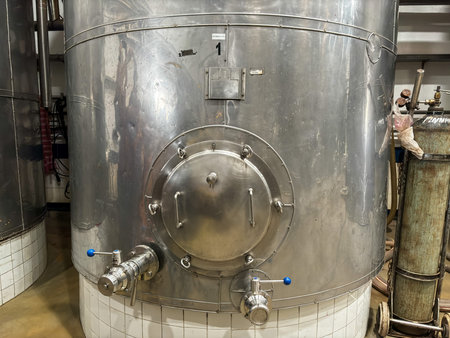 A large industrial view of metal barrels used for fermentation of grapes for making wine, Sulu...