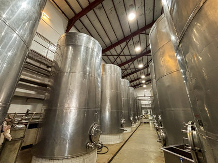 A large industrial view of metal barrels used for fermentation of grapes for making wine, Sulu...