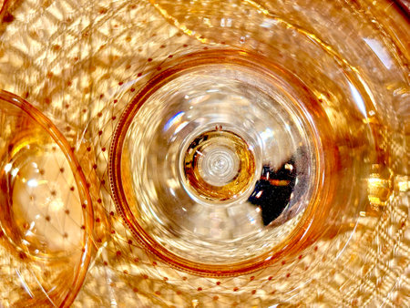 The image is a close up of a piece of glass with a yellowish tint. The glass appears to be a part of a larger piece of glass, and the yellowish tint gives it a warm, inviting feelの写真素材