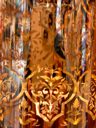 The image is a close up of a piece of glass with a yellowish tint. The glass appears to be a part of...