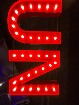 A red neon sign with the letters Z and N. The sign is lit up with red lights and he is glowingの写真素材