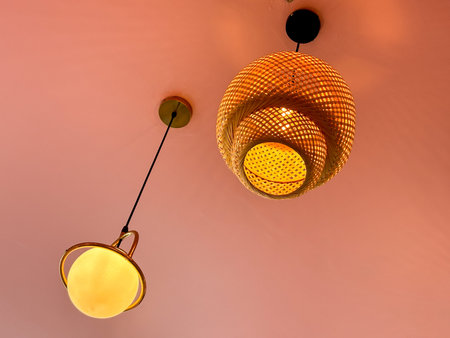 A series of hanging lights with a yellow glow. The lights are hanging from the ceiling and are...