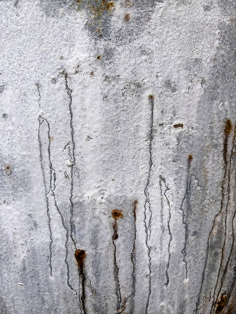 The wall has a lot of scratches and marks, giving it a worn and aged appearance. The marks are in various sizes and shapes, and they seem to be from different sources, such as graffiti or vandalismの写真素材