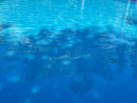 The water is calm and clear, reflecting the sky and the surrounding area. Concept of tranquility and serenityの写真素材