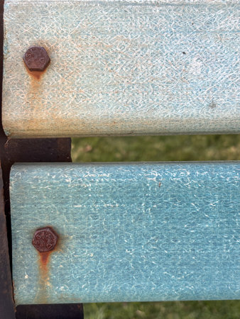 Two wooden boards with a blue and white pattern. The blue board has a few rusty spots