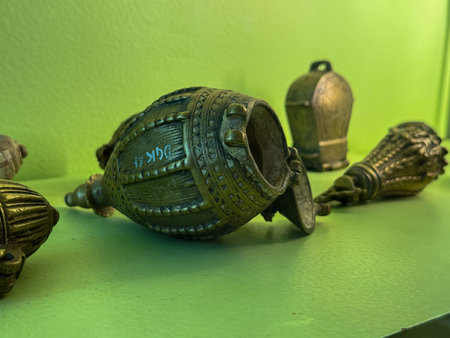 A collection of brass objects with the numbers 1734 on one of them. The objects are arranged on a...