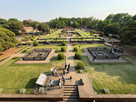 A large park with a lot of people walking around. The park is very green and has a lot of trees, Shaniwar Wada Pune.の写真素材